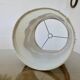 Ceramic lamp with double lighting and openwork design.