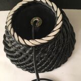 Table lamp with black porcelain support in the shape of a woven basket and opaque glass ball globe