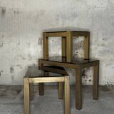 Trio of nesting tables, brass structures and smoked mirror tops