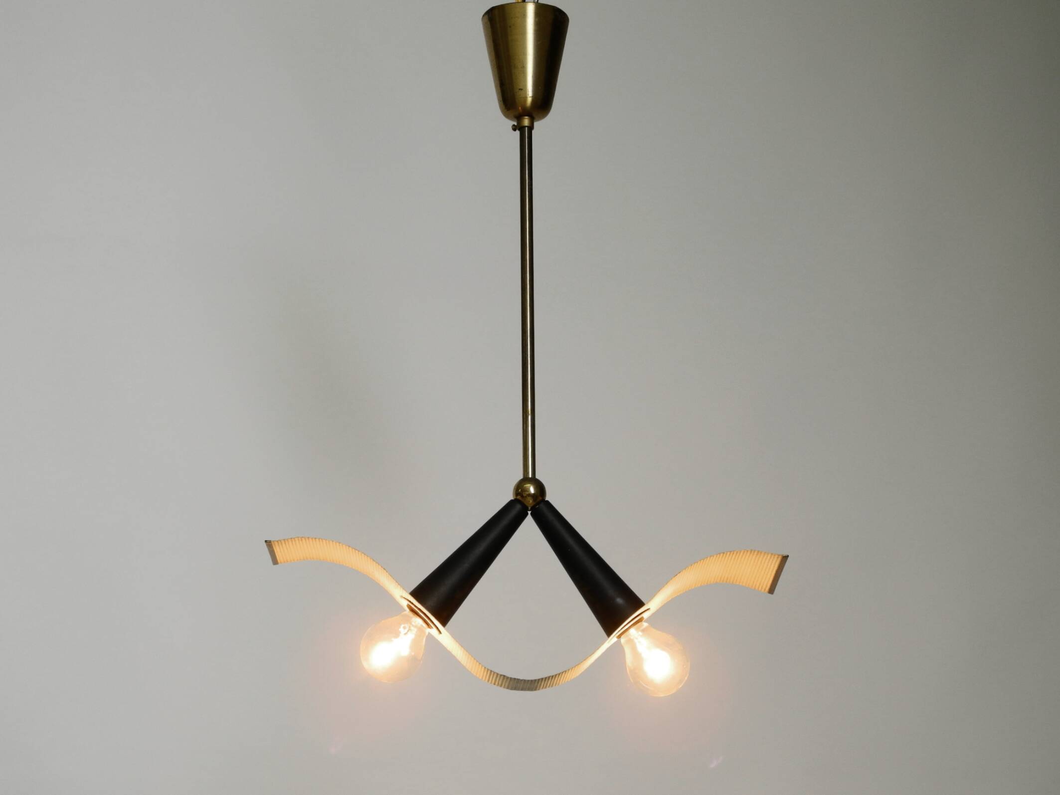 Mid Century brass ceiling lamp with a curved perforated sheet lampshade