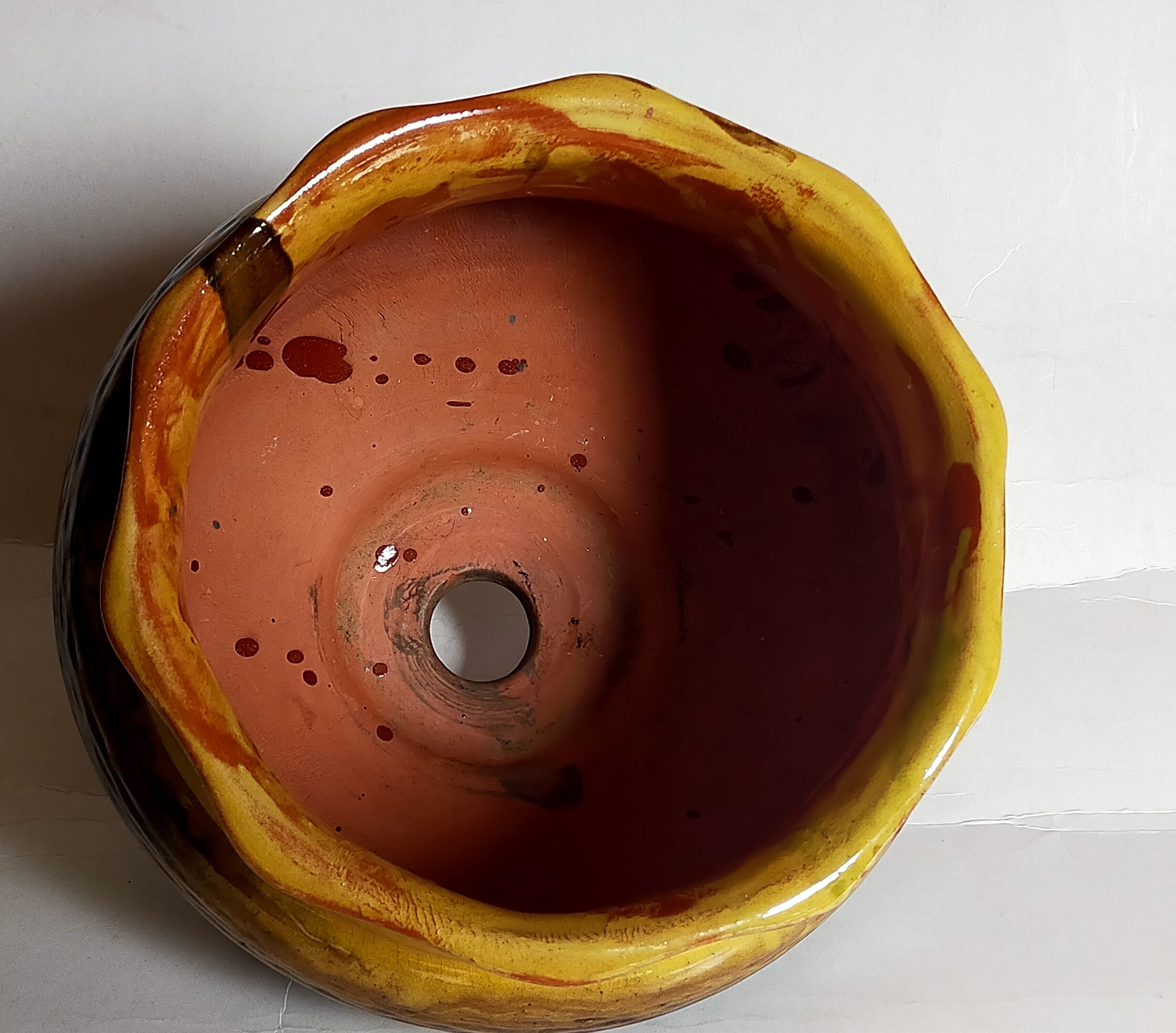 Old provencal pot cover in glazed terracotta