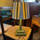 Pair of vintage wooden lamps with their striped beige, blue, and green shades.