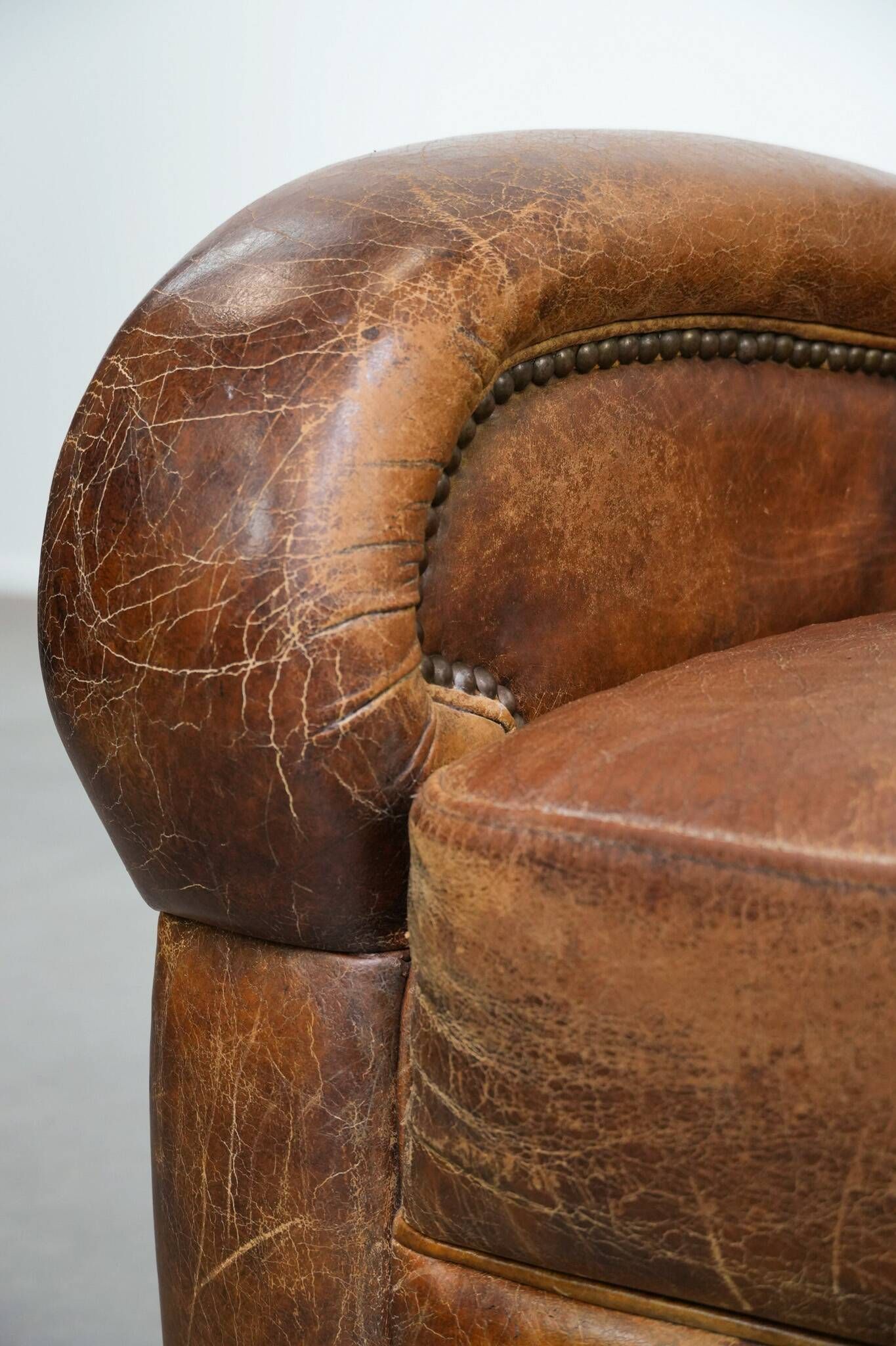 Charming and comfortable vintage armchair in grained cowhide leather with character