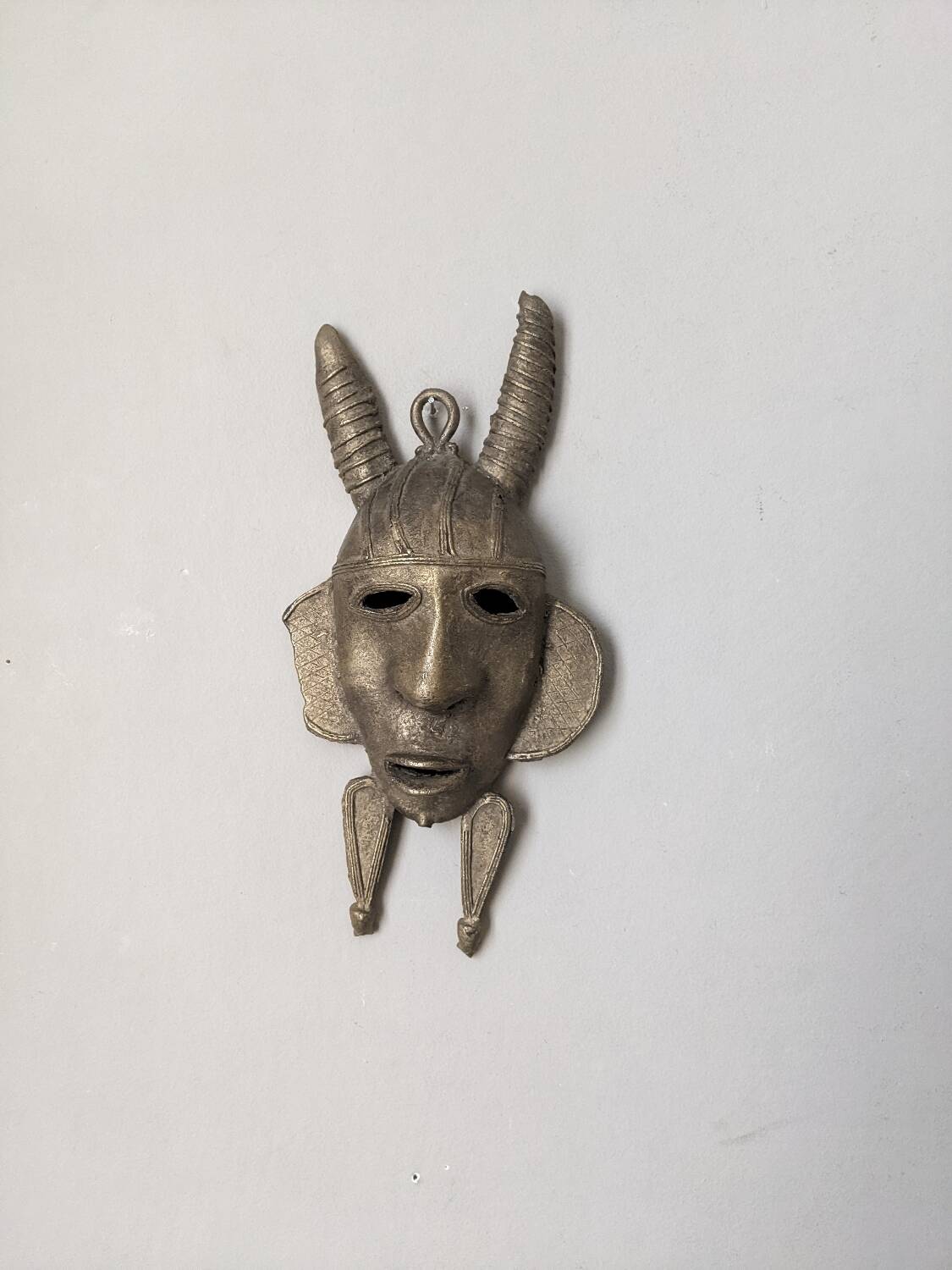 Handcrafted bronze wall mask, Sénoufo African art.