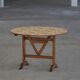 19th-century French round wine table with an adjustable top and floral textile surface.