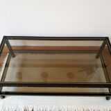 Black and gold coffee table with a double smoked glass top