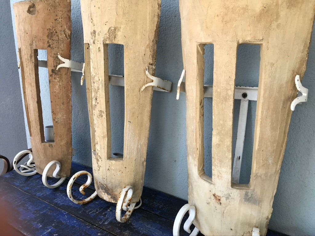 Lot of three terracotta and wrought iron appliques