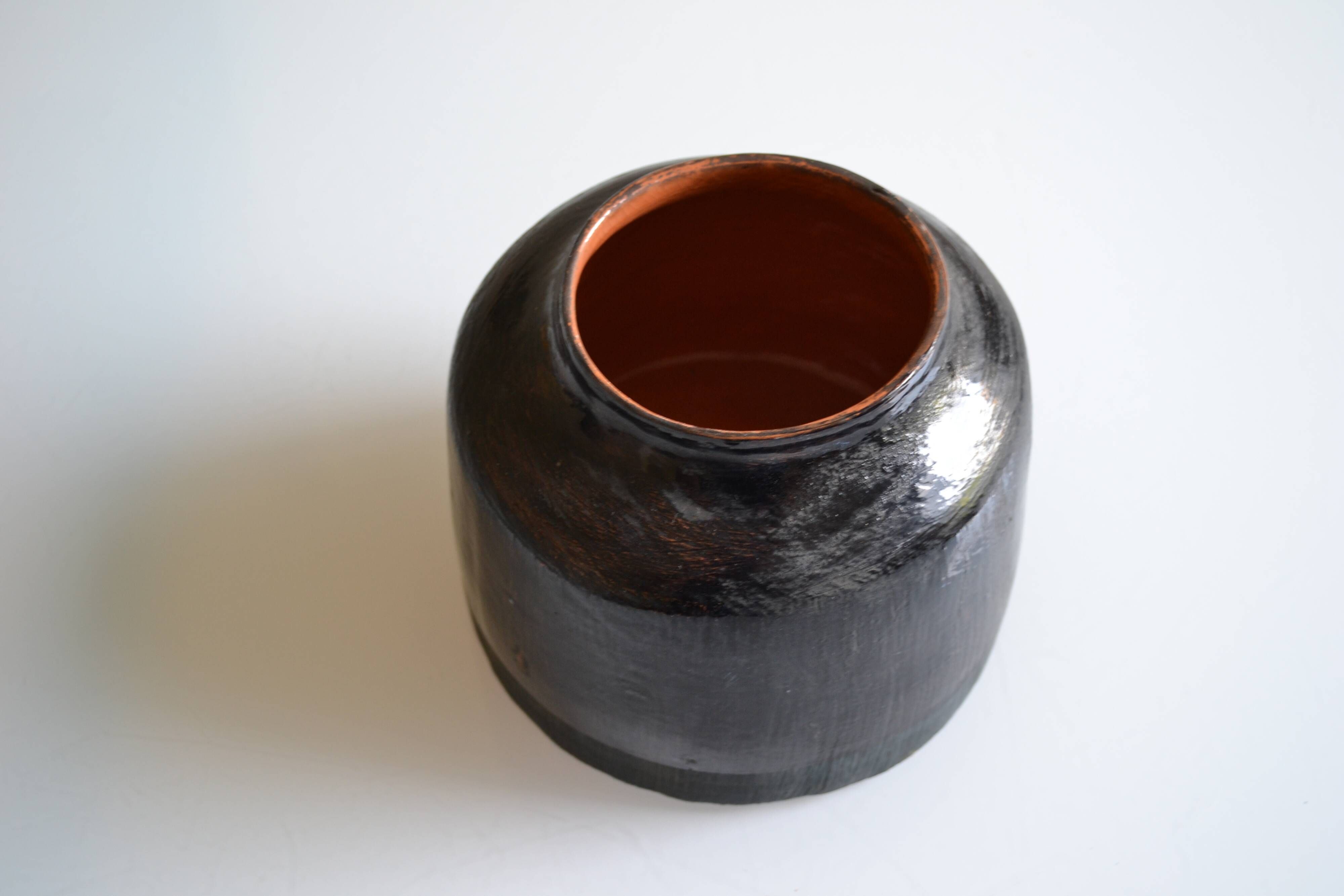 Ceramic vase with a signature fish to identify.