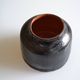 Ceramic vase with a signature fish to identify.