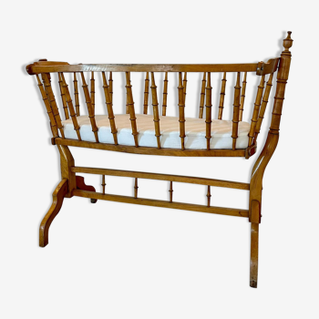Old wooden cradle with mattress