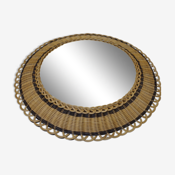 Vintage round mirror in a wicker frame