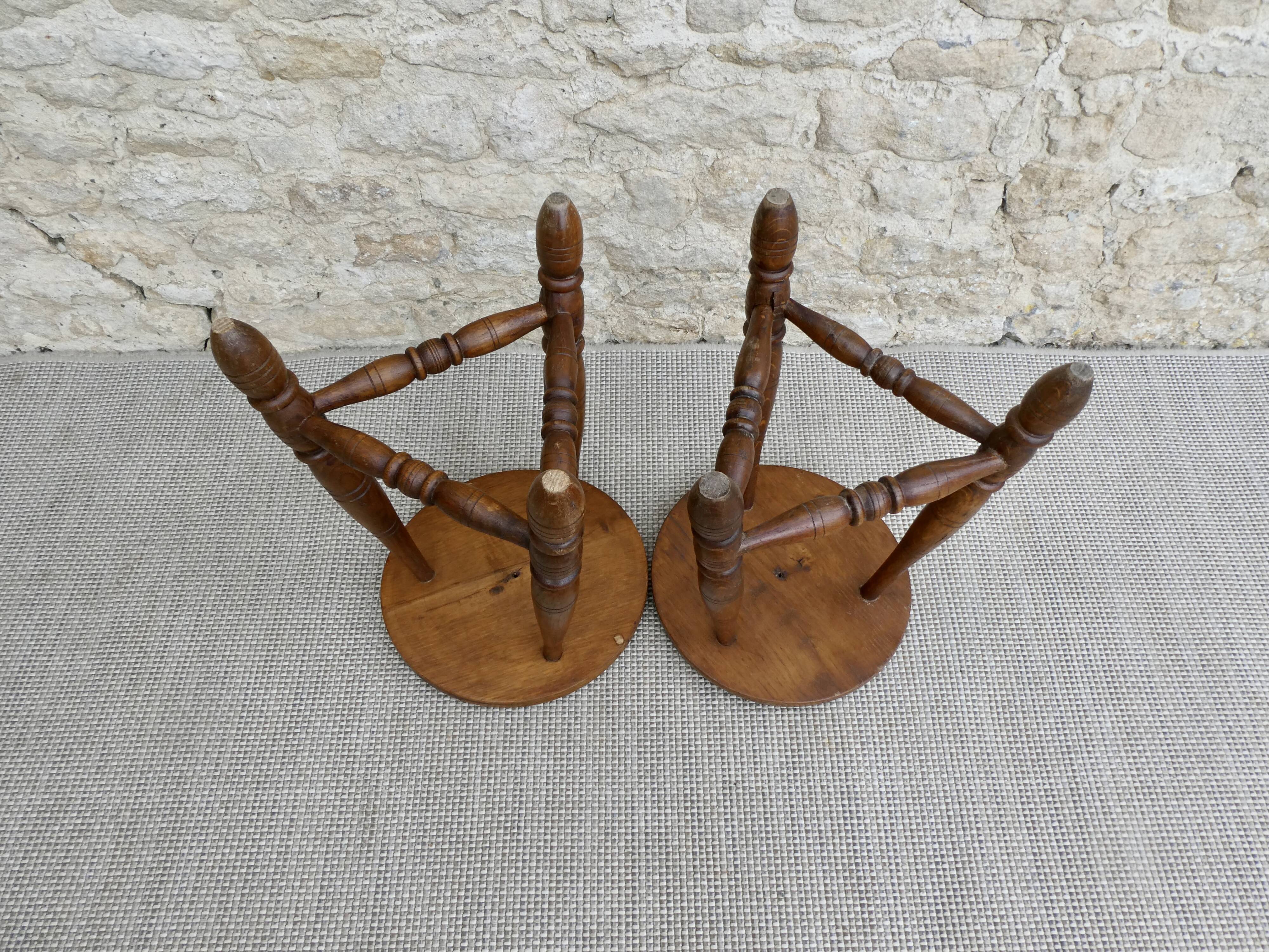 Pair of solid wood tripod stools, carved.