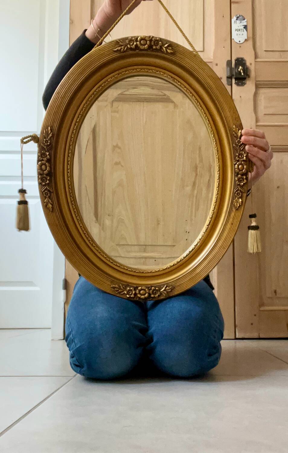 Oval gilt mirror and Art Deco trim