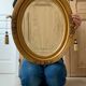 Oval gilt mirror and Art Deco trim