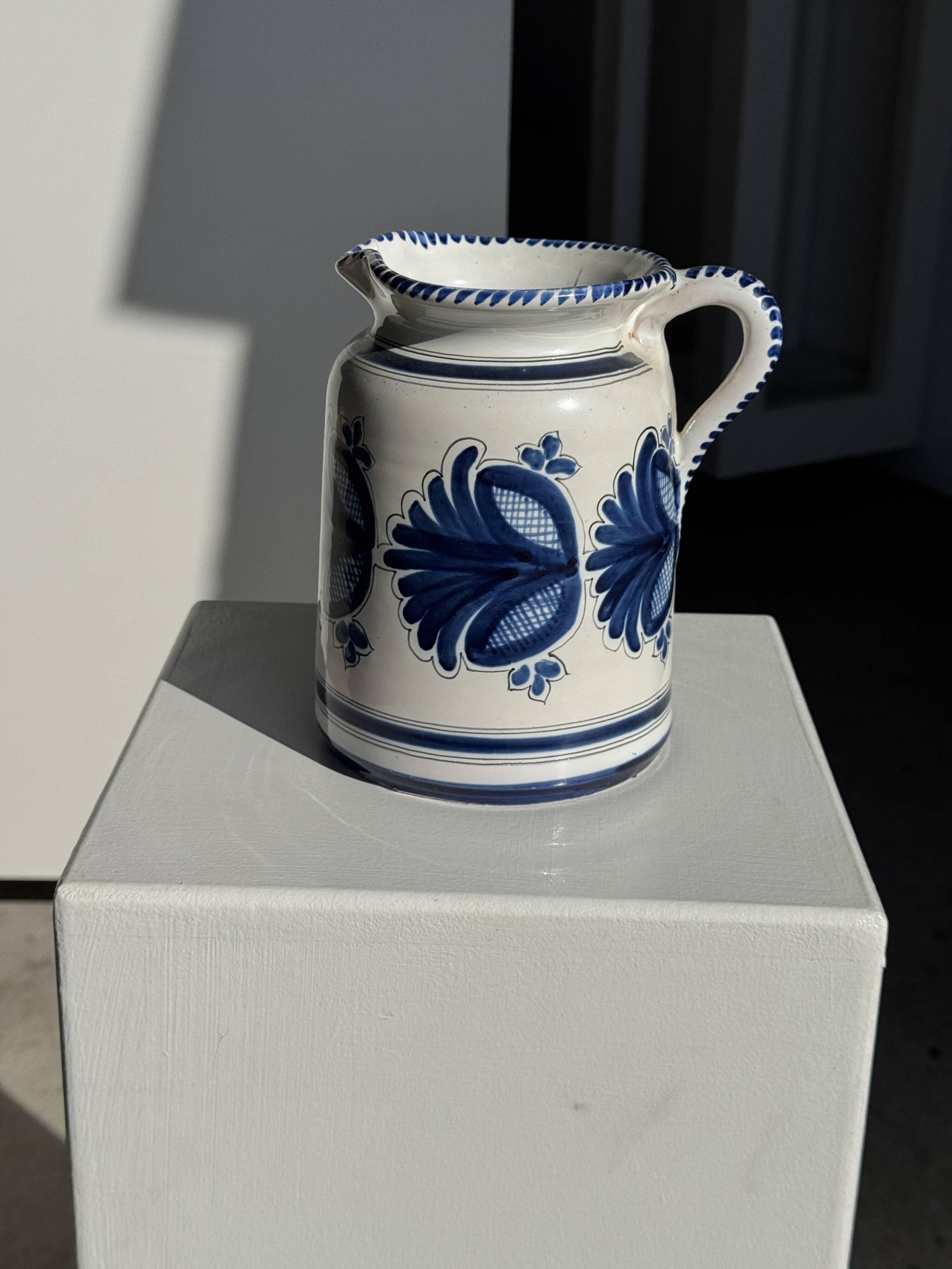 Artisan blue floral decorative carafe, height 17 cm, diameter 24.5 cm.