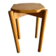 Vintage solid wood stool with an organic-shaped seat.