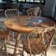 Round dining table Audoux Minet with 4 chairs and 2 armchairs.