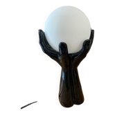 Lamp hands holding a globe