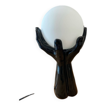 Lamp hands holding a globe