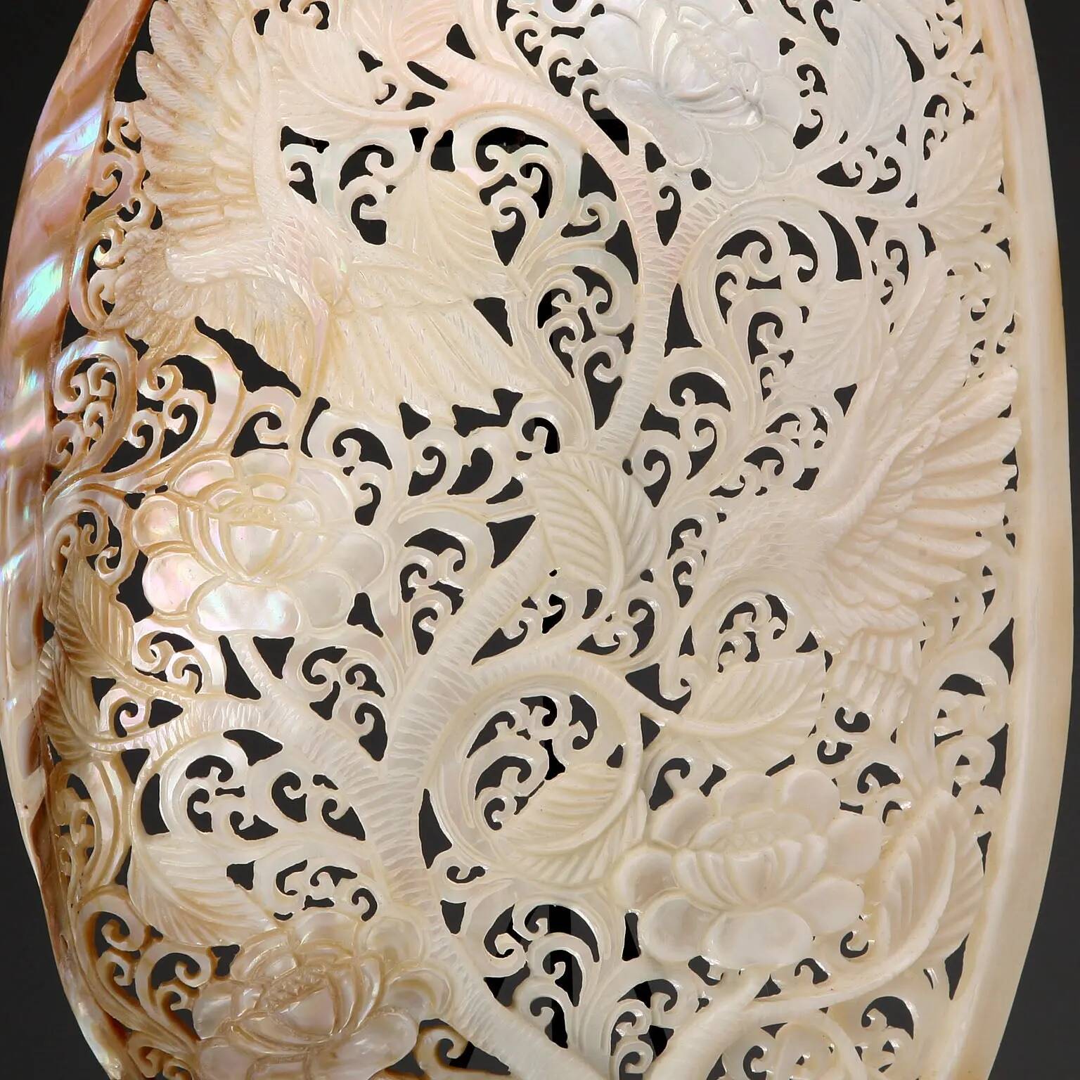 Perforated shell hand-decorated on a wooden base