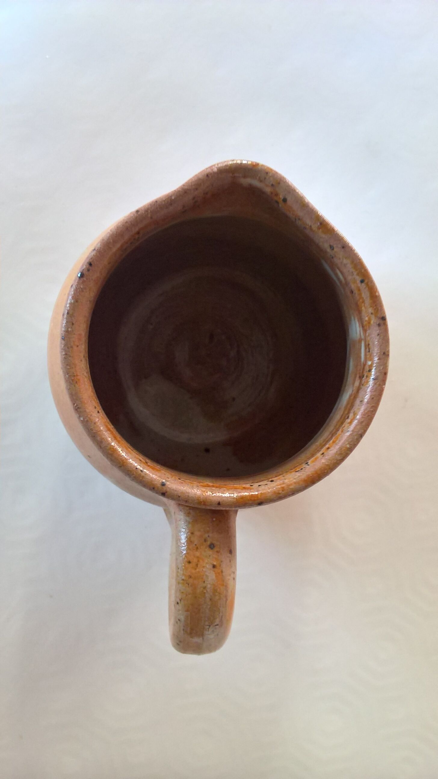 Creamy milk pot in sandstone