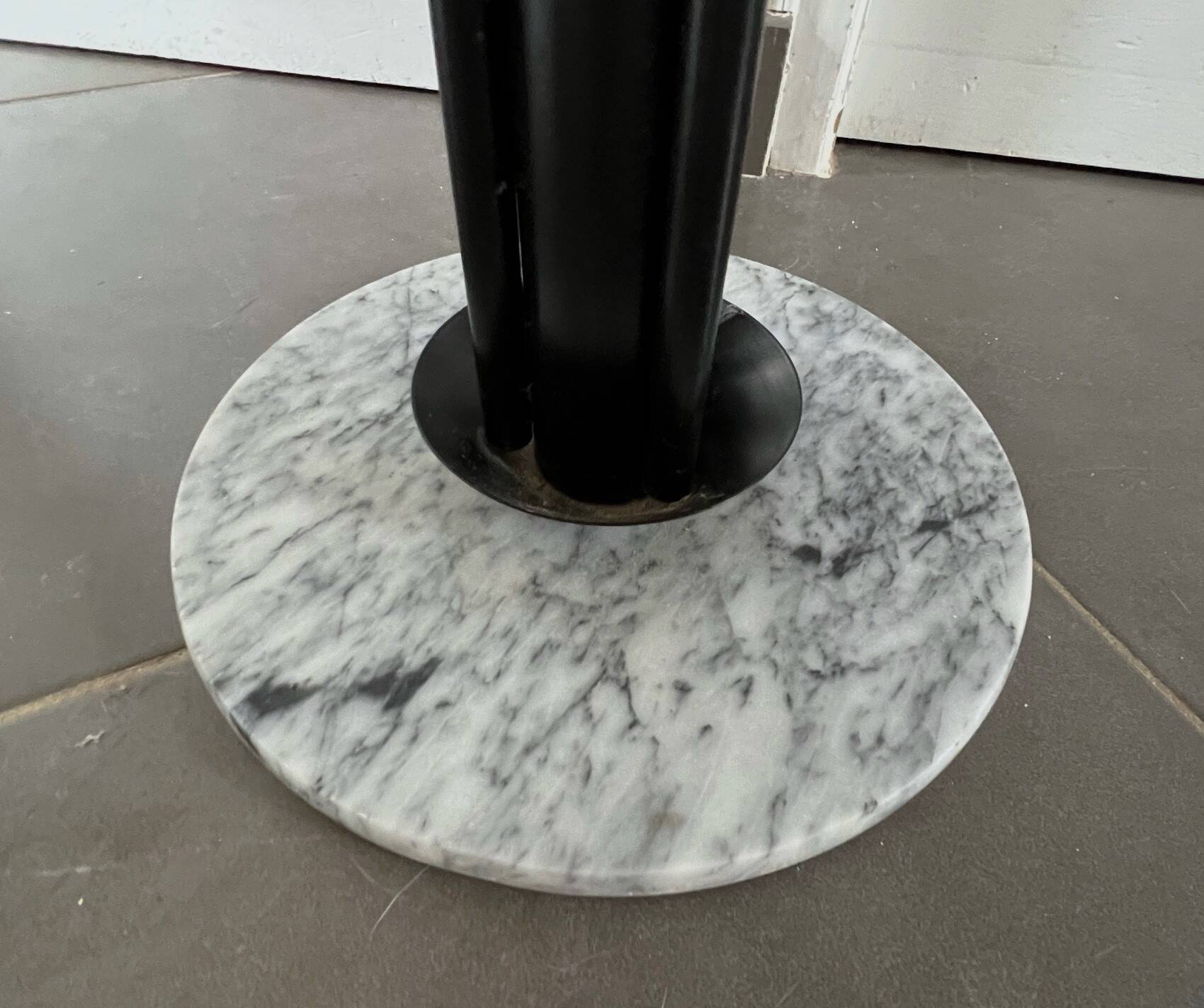 Black metal parrot coat rack on marble base