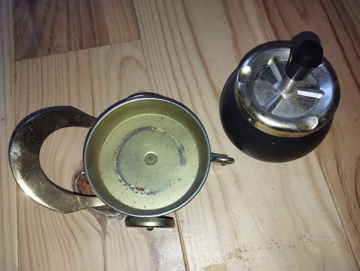 Original vintage ashtray on a small wheeled stand.