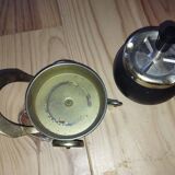 Original vintage ashtray on a small wheeled stand.