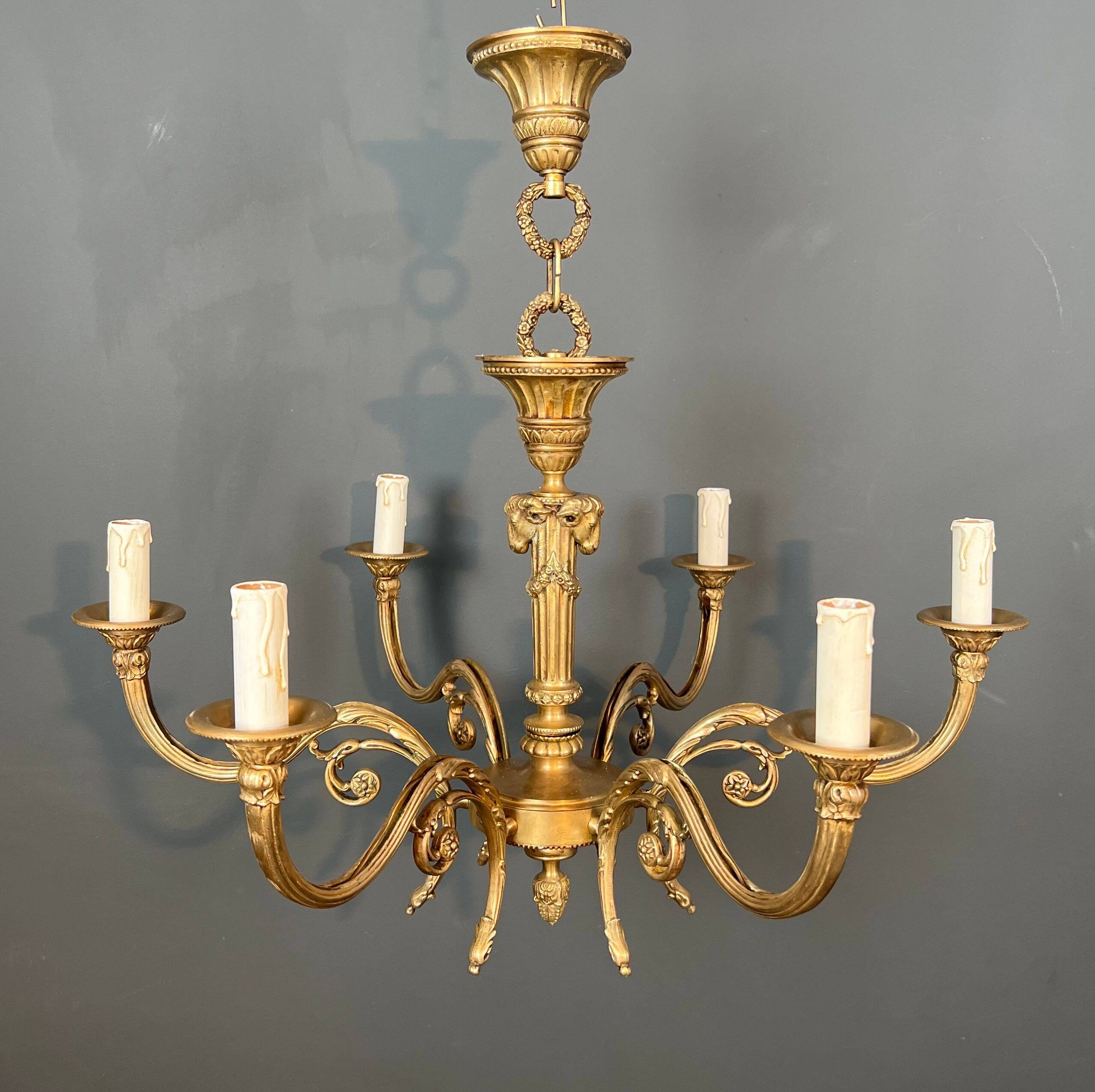 Bronze chandelier with ram's head motifs in the Louis XVI style, in the manner of Maison Jansen.