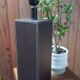 Tall cubic brown leather lamp, light gray fabric lampshade