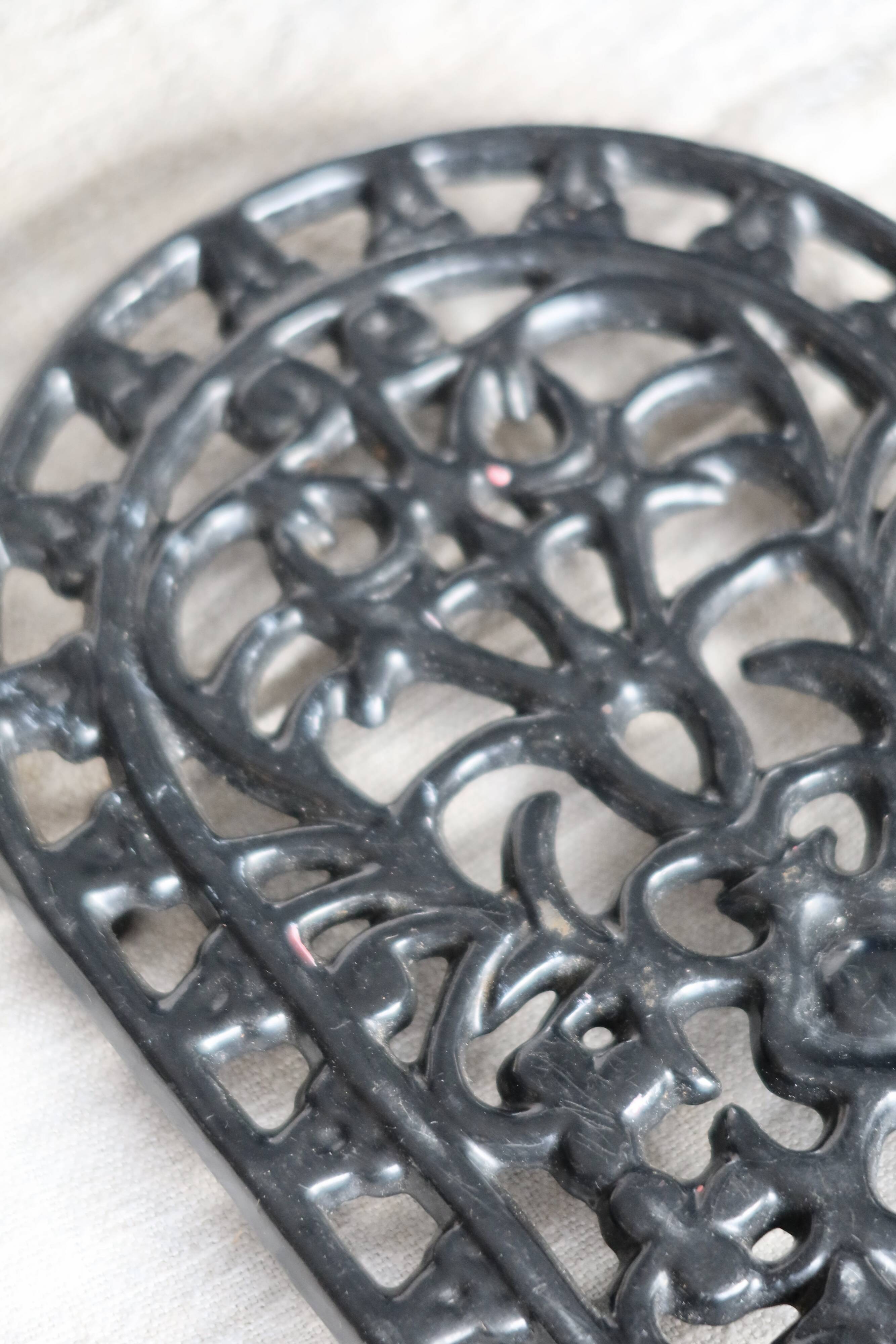 Vintage black cast iron oval trivet - Openwork design