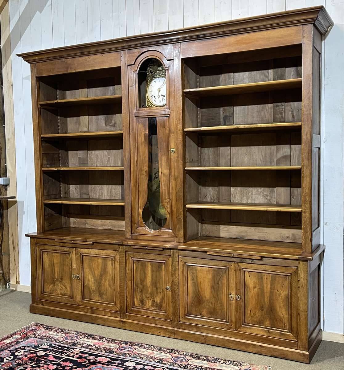 Library in walnut and oak from the early 20th century with its central clock.