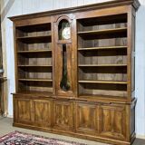 Library in walnut and oak from the early 20th century with its central clock.