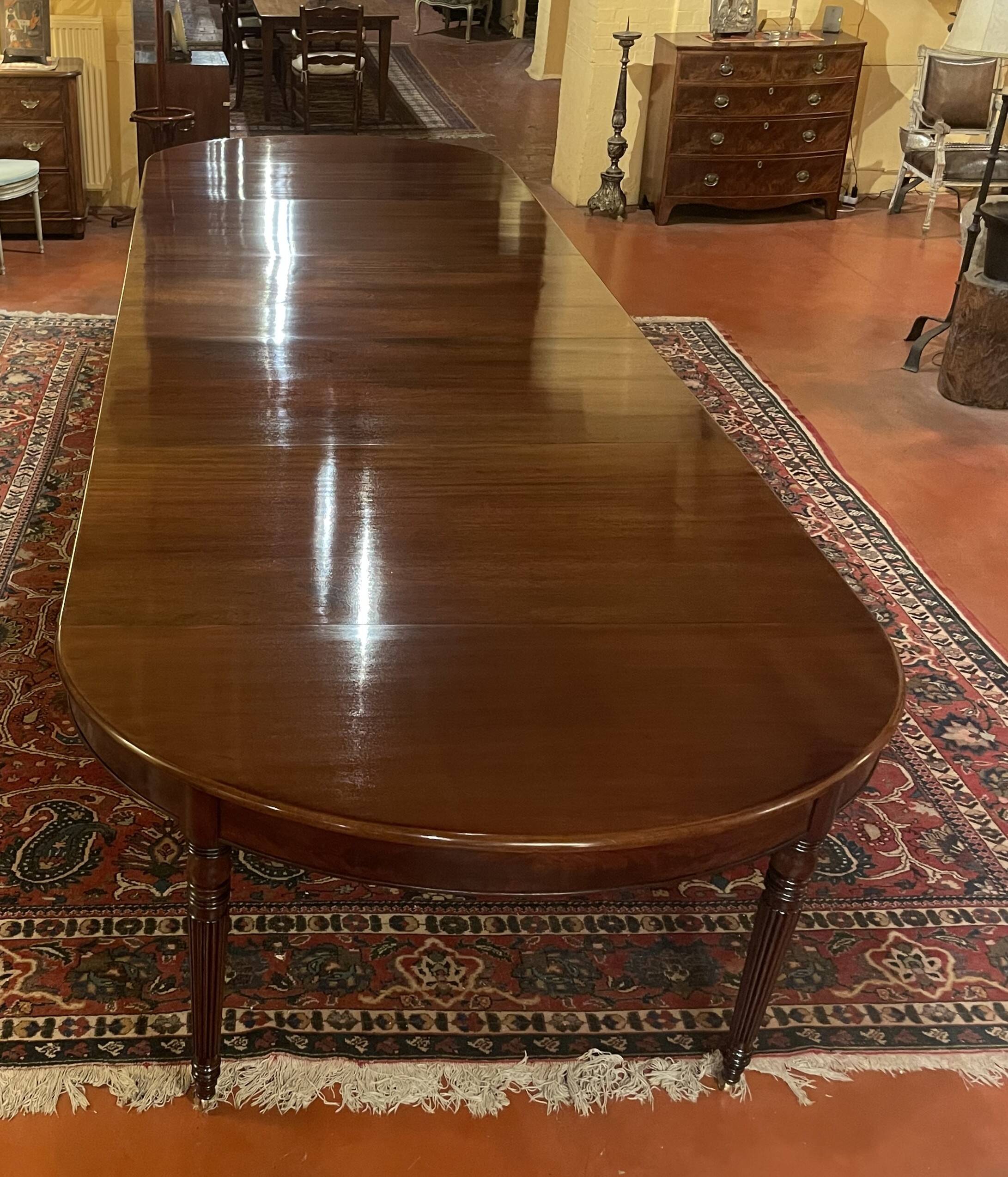 Extensible dining table from the Louis XVI period in mahogany with a banded top.
