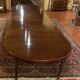 Extensible dining table from the Louis XVI period in mahogany with a banded top.