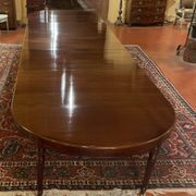 Extensible dining table from the Louis XVI period in mahogany with a banded top.