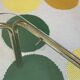 Pair of small nesting coffee tables in gold tubular metal & transparent glass tops