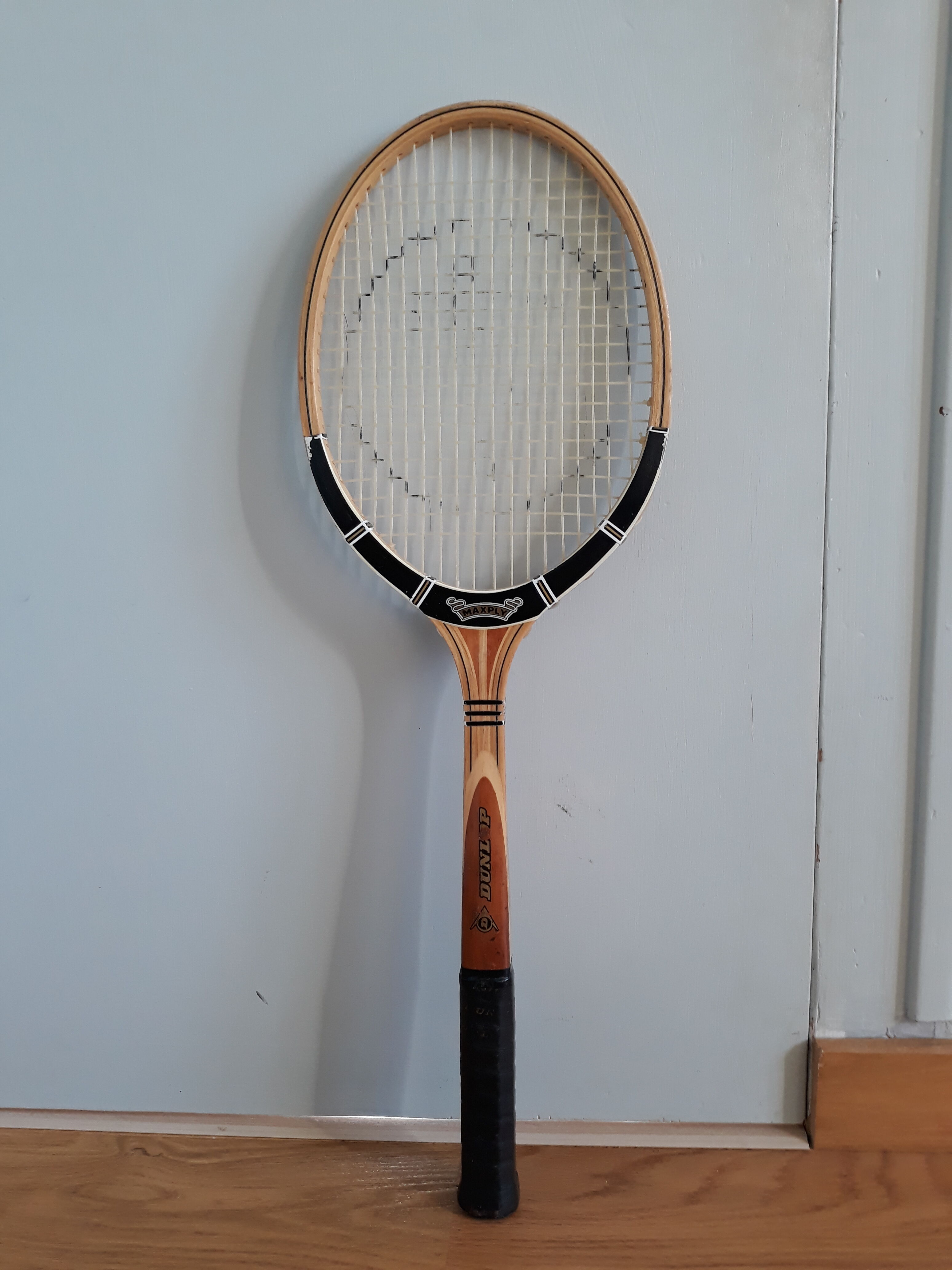 Wooden Dunlop tennis racket with its cover