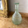 Large blown green glass decanter and relief decoration