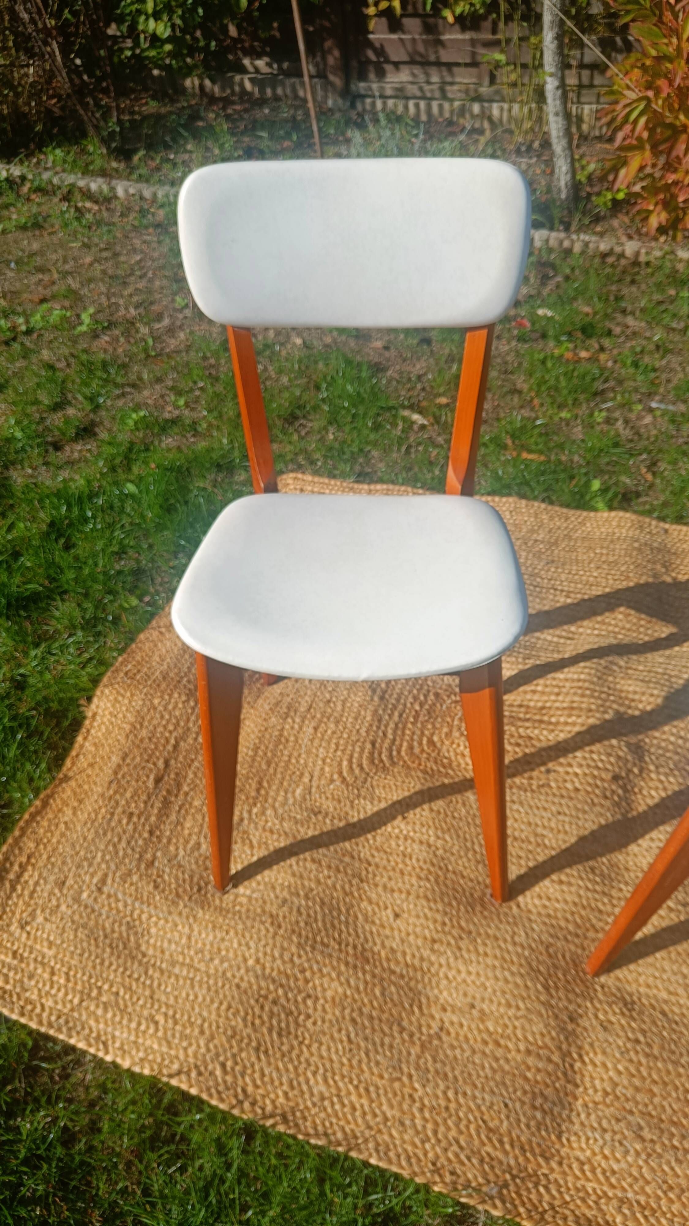 vintage wooden chairs with white faux leather