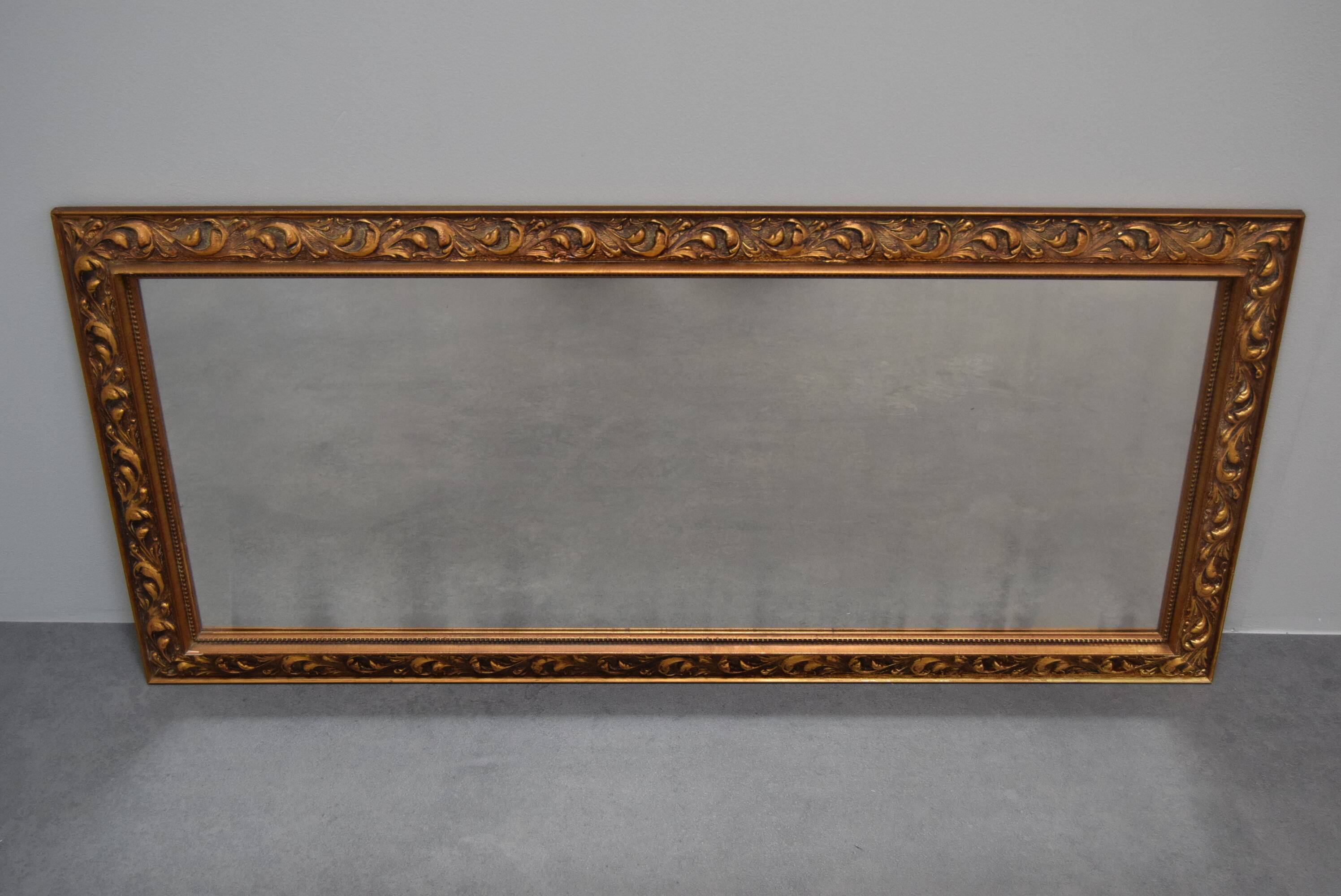 wall mirror in a decorative wooden frame.