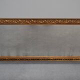 wall mirror in a decorative wooden frame.