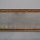 wall mirror in a decorative wooden frame.