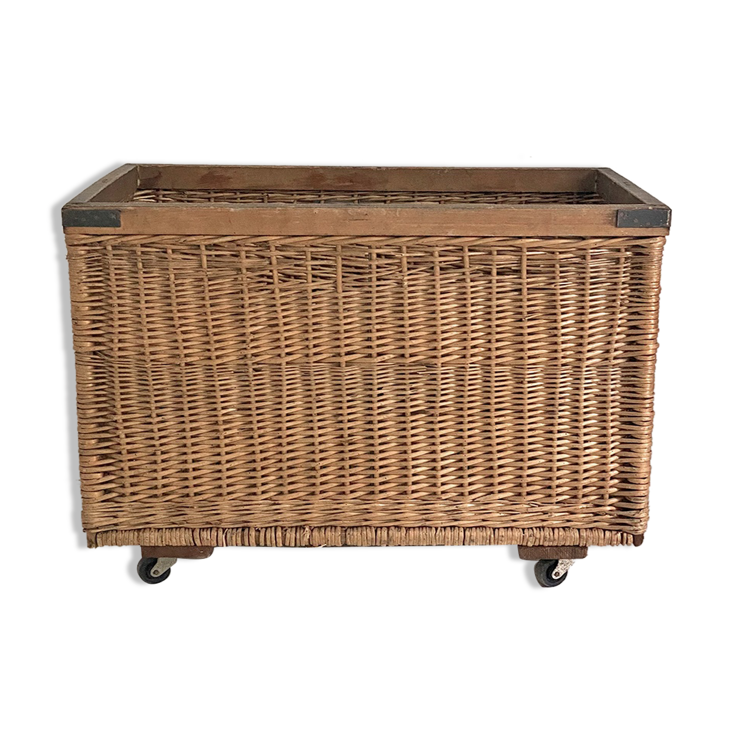 Old large wicker laundry basket on wheels