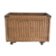 Old large wicker laundry basket on wheels