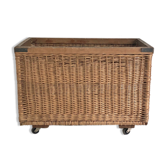 Old large wicker laundry basket on wheels