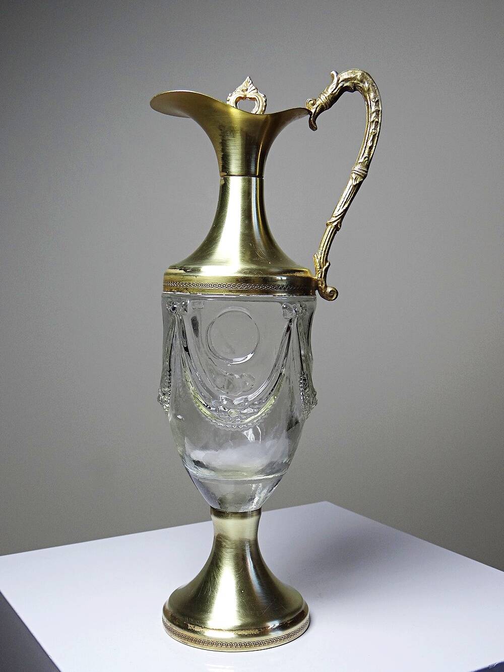 Vintage decorative jug in moulded glass and gilded brass, Italy circa 1980.