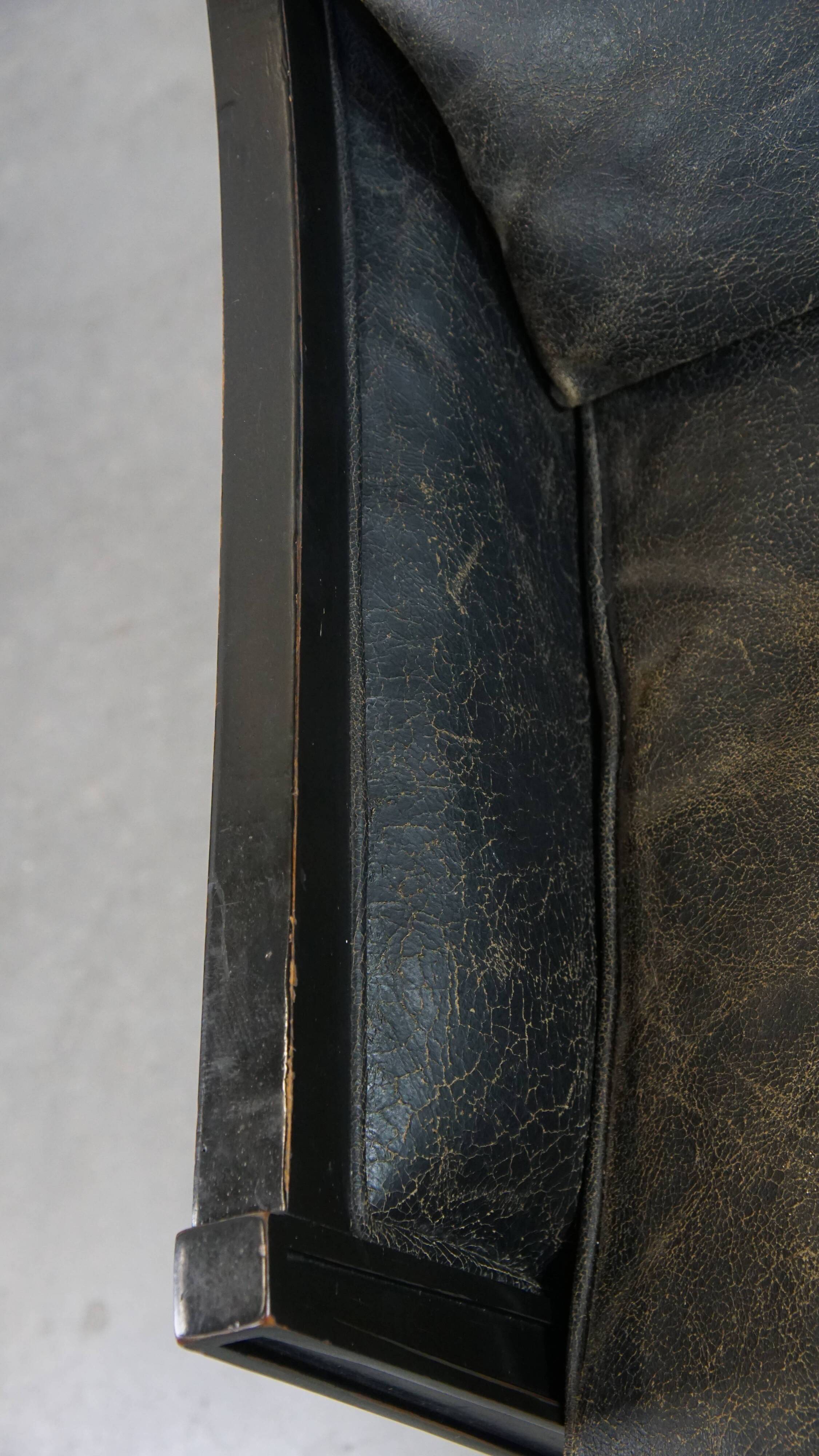 Armchair in black cowhide leather and wood with an Art Deco design