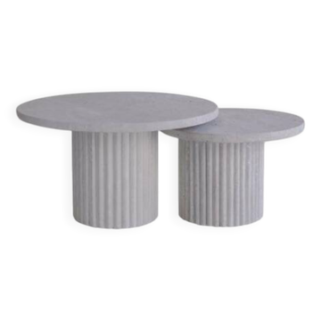 Round Omega nesting coffee tables in natural travertine.