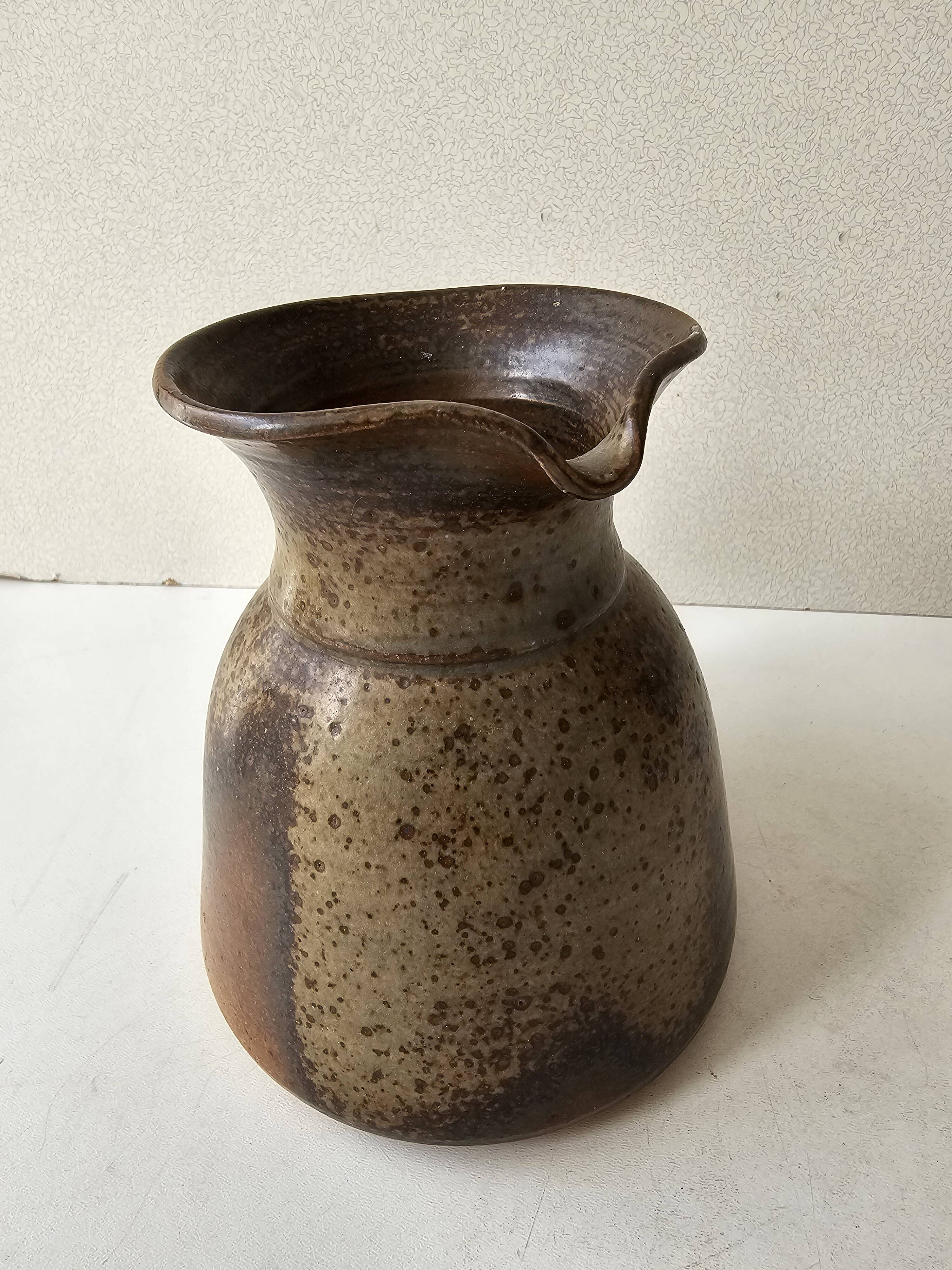 Pyrithed stoneware ceramic pitcher signed GRh. (signature to be identified)